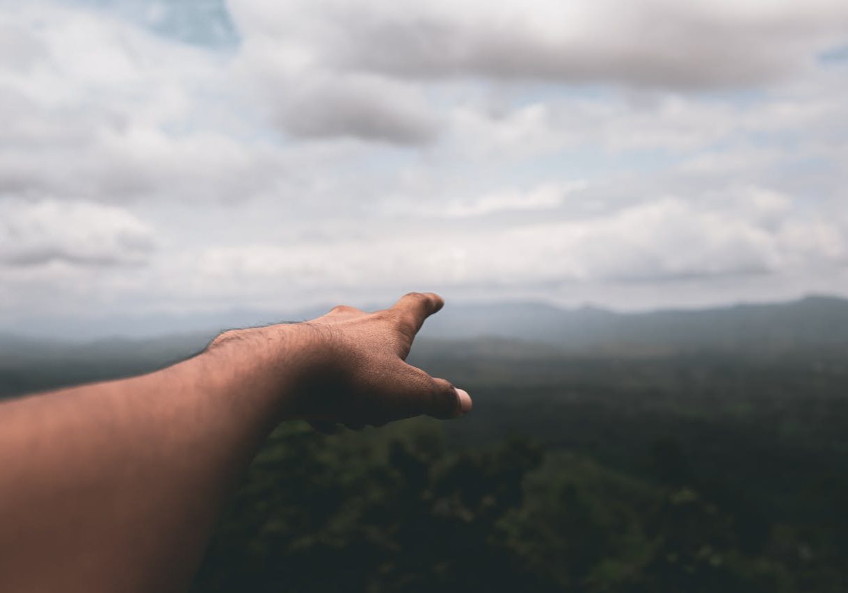 Outstretched arm pointing to the sky, representing wellness and new beginnings.