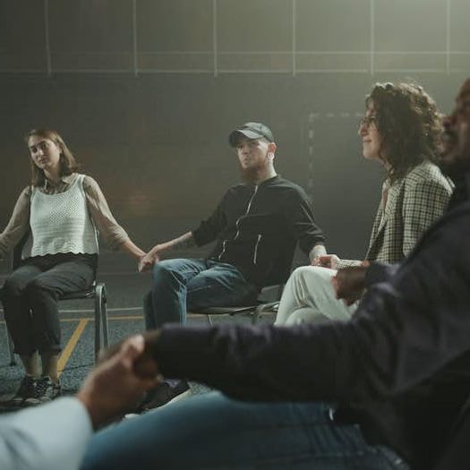 People participating in group counseling session, supportive therapy for addiction recovery and wellness